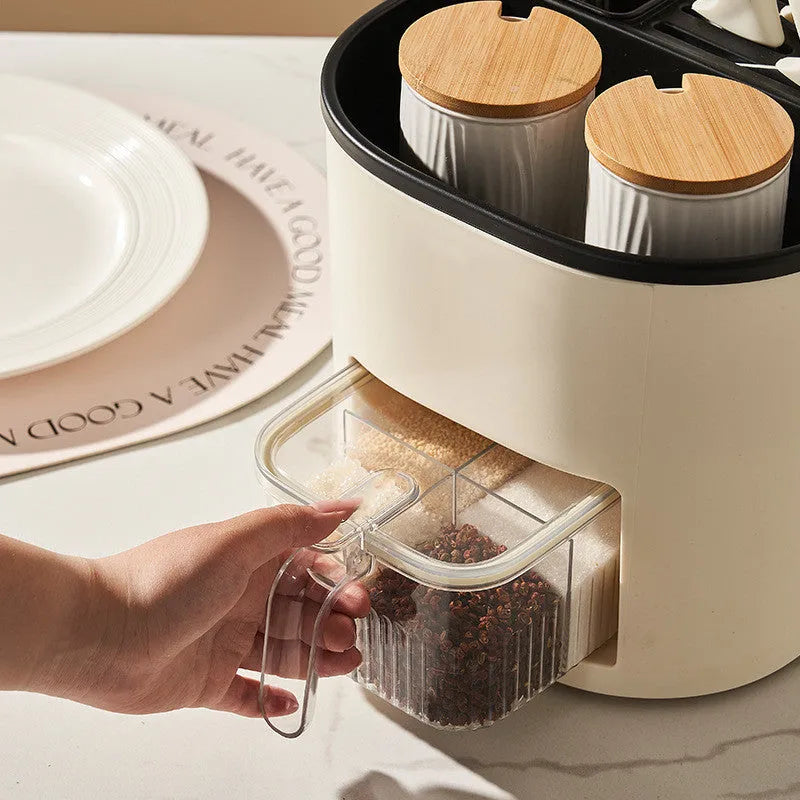 White rotating kitchen storage bucket with attached four-compartment spice box for utensils and seasonings.