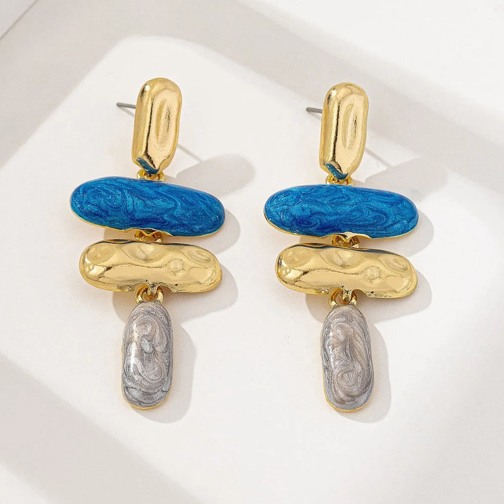 A pair of geometric-shaped stud earrings with a multicolour electroplated metal finish.