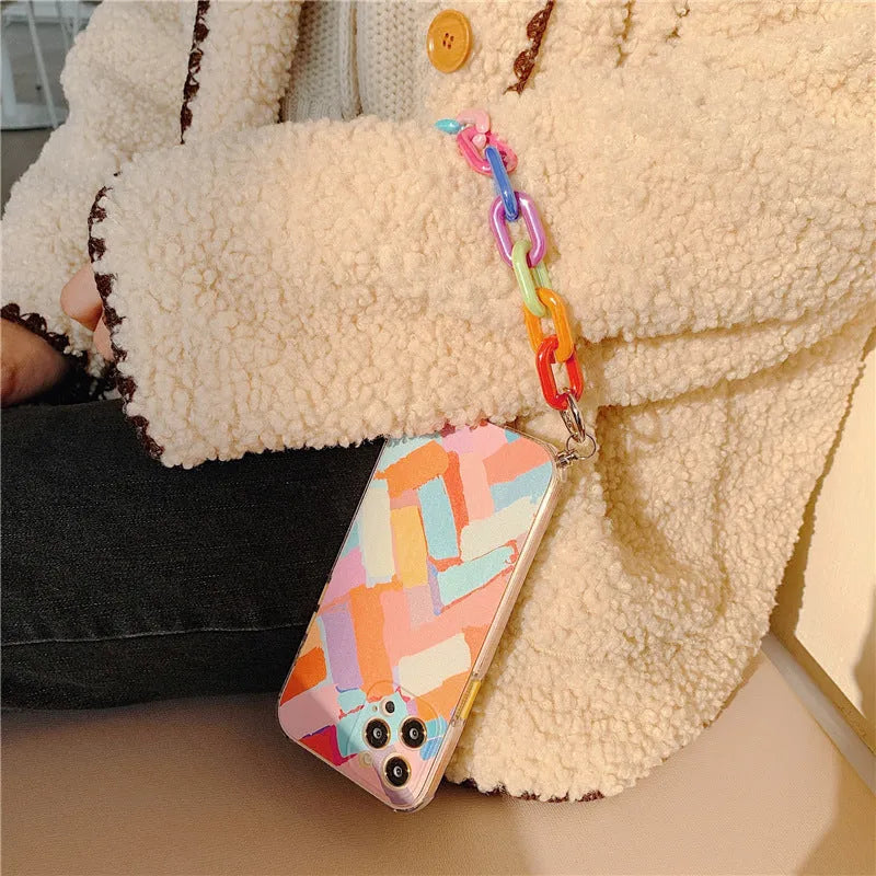 Clear TPU mobile phone case with printed graffiti design and integrated wrist strap attachment for iPhone