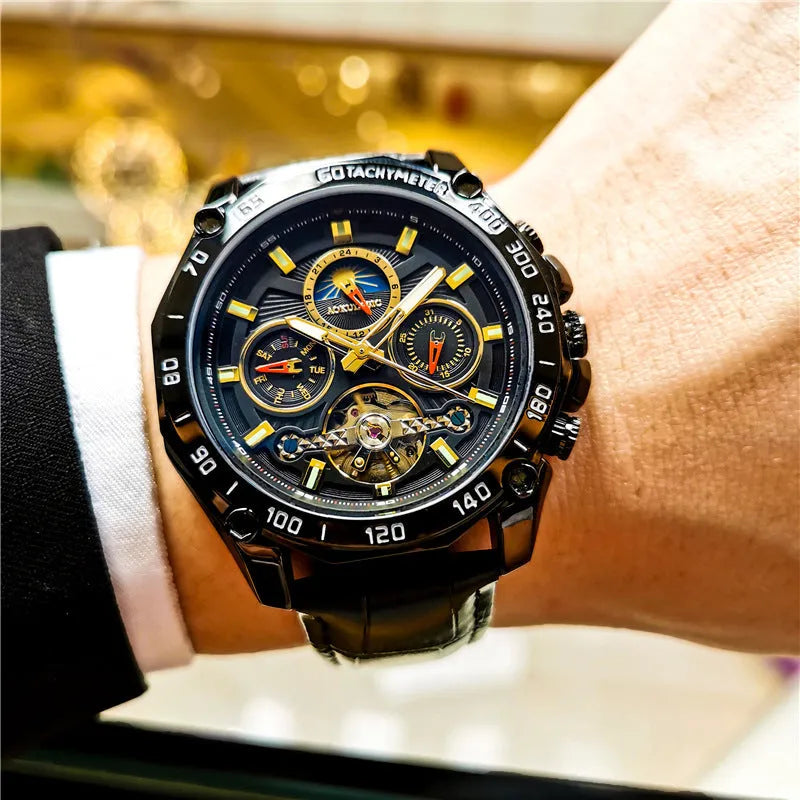 Men's automatic mechanical watch on wrist showing silver metal case and black dial.