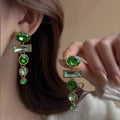 A pair of geometric green gradient alloy earrings with tassel design and inlaid zircon stones.