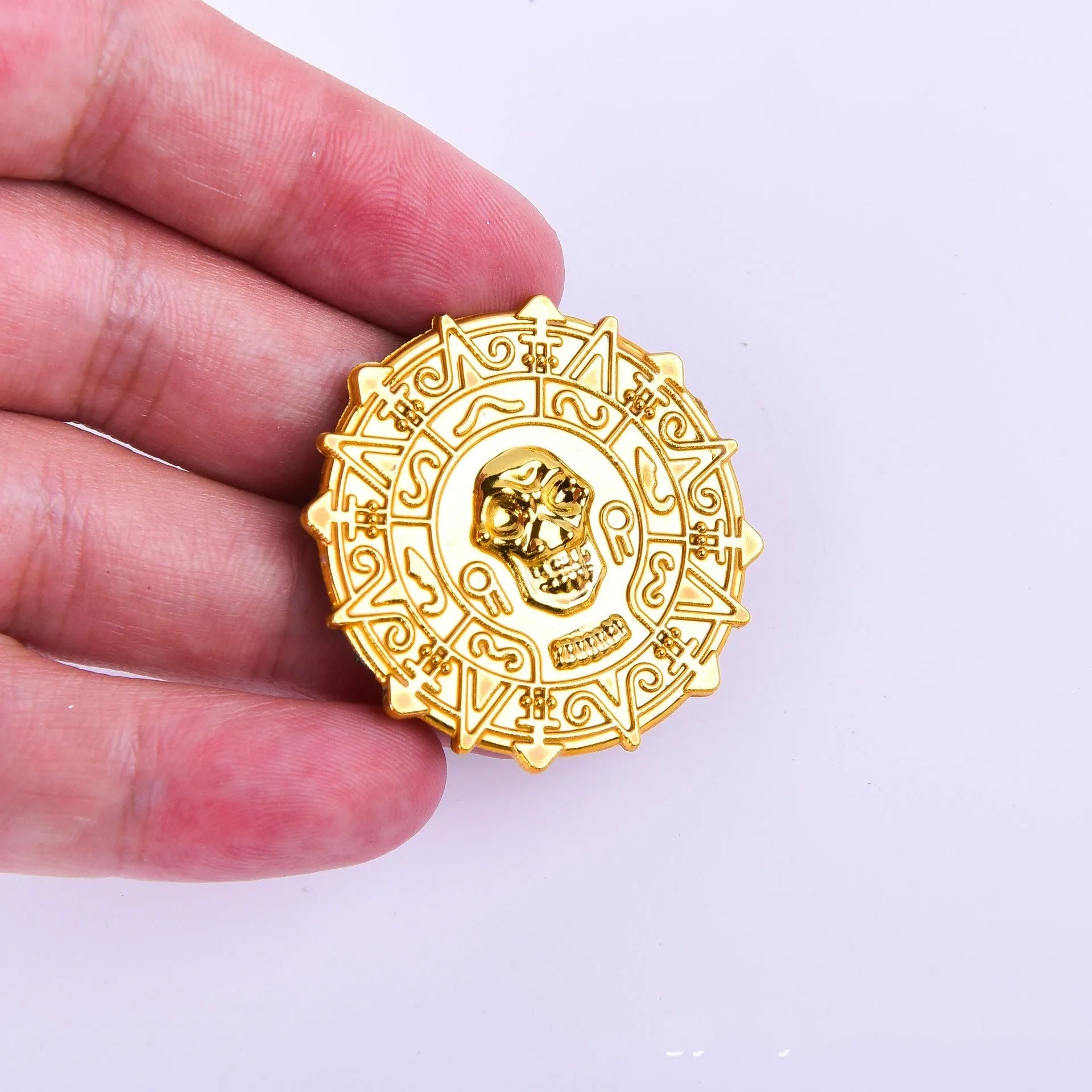 Plastic pirate gold coin with pointed tip styling measuring 3.6cm diameter