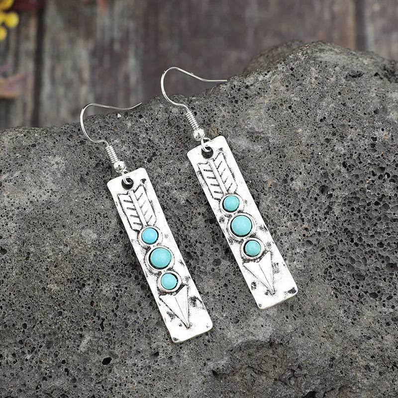 Long geometric silver earrings with turquoise inlay detail, retro style women's jewellery
