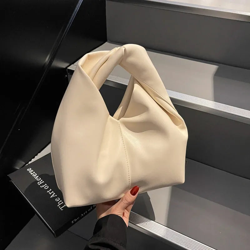 Women's PU leather dumpling-shaped handbag in multiple colours with folding stitch details measuring 24x10x21cm