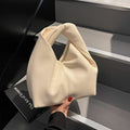 Women's PU leather dumpling-shaped handbag in multiple colours with folding stitch details measuring 24x10x21cm