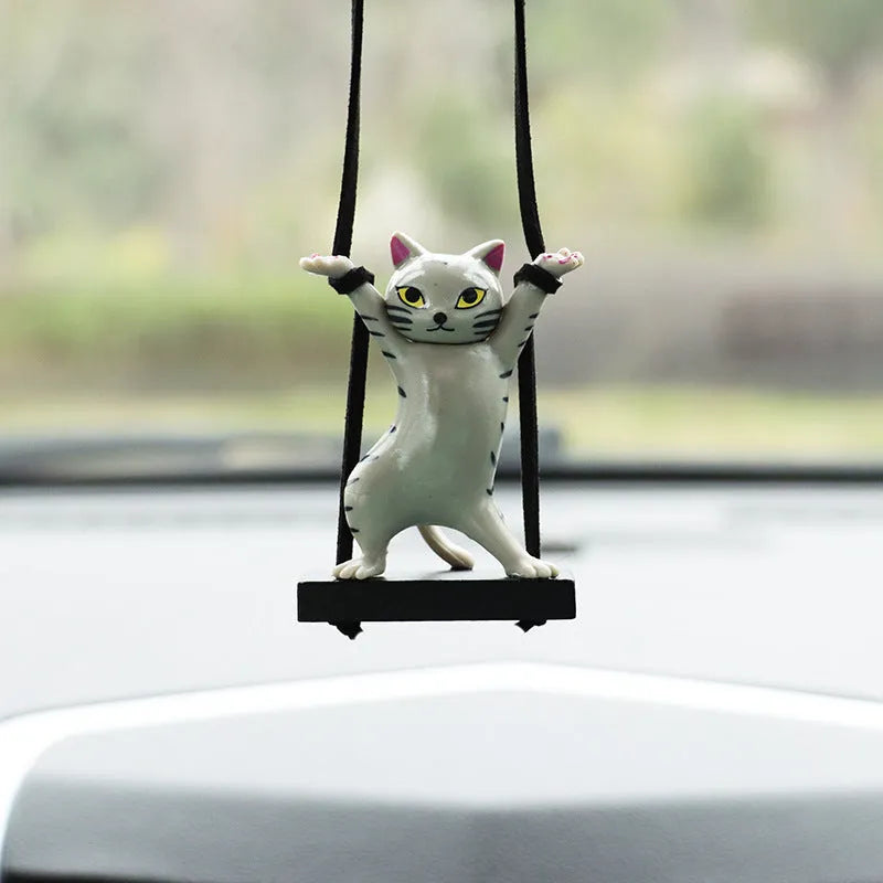 Cartoon-style resin cat pendant for car interior decoration with adjustable rope.
