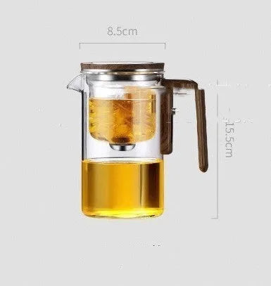 Glass teapot with wooden handle showing magnetic separation mechanism for loose leaf tea brewing