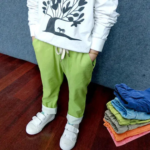 Orange cotton and linen cropped trousers for children with elastic waistband