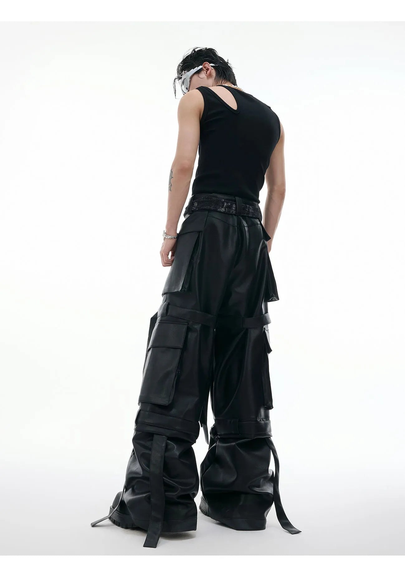 Men's black loose-fit trousers with quilted panels, heavy stitching, and multiple pockets.