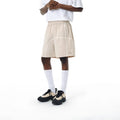 Dark grey high elasticity polyester drawstring shorts with loose fit on a beach background