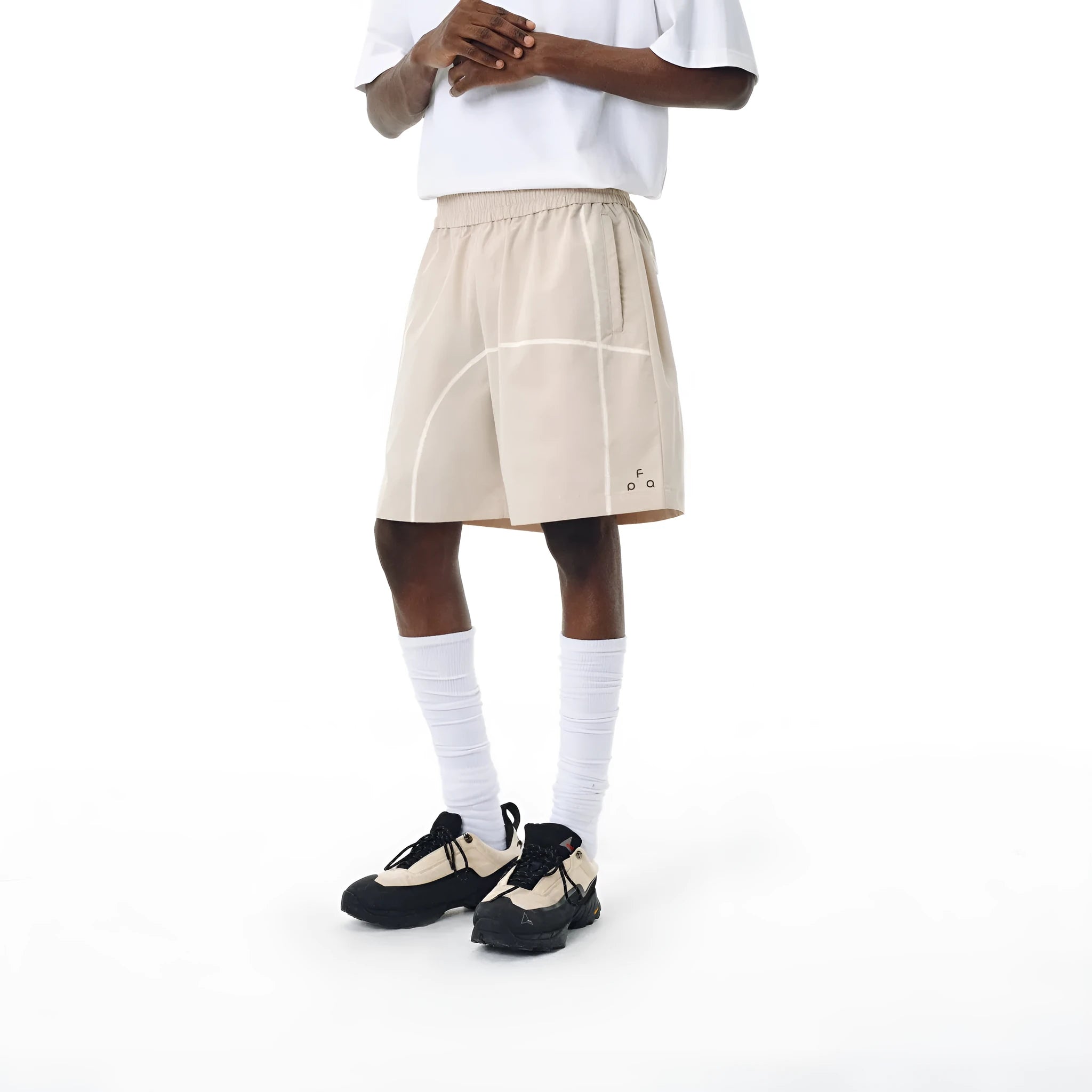 Dark grey high elasticity polyester drawstring shorts with loose fit on a beach background