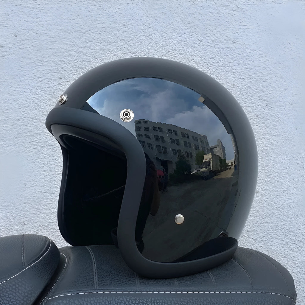 A retro-style fibreglass half motorcycle helmet shown in a cement grey colour, suitable for adult commuting.