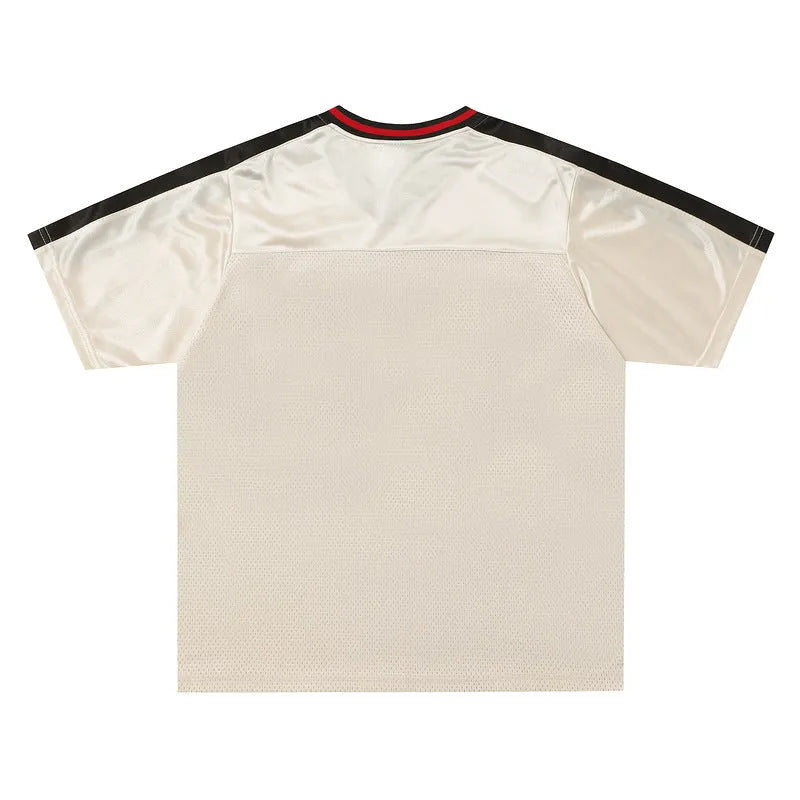 Apricot-coloured loose fit sports T-shirt with a printed letter design and drop-shoulder sleeves.