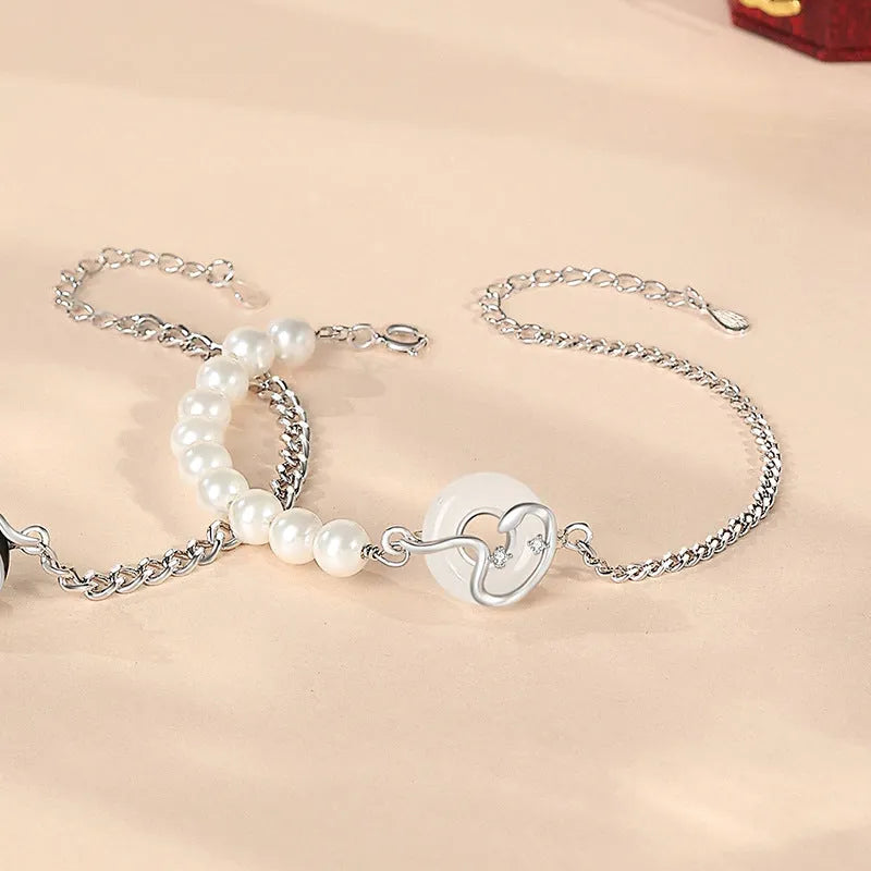 925 sterling silver couple bracelet with safety buckle, obsidian pearl, and Chinese zodiac snake design.