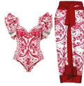Women's printed polyester one-piece swimsuit on a hanger, showing rose pink, blue, white, and red colour options.