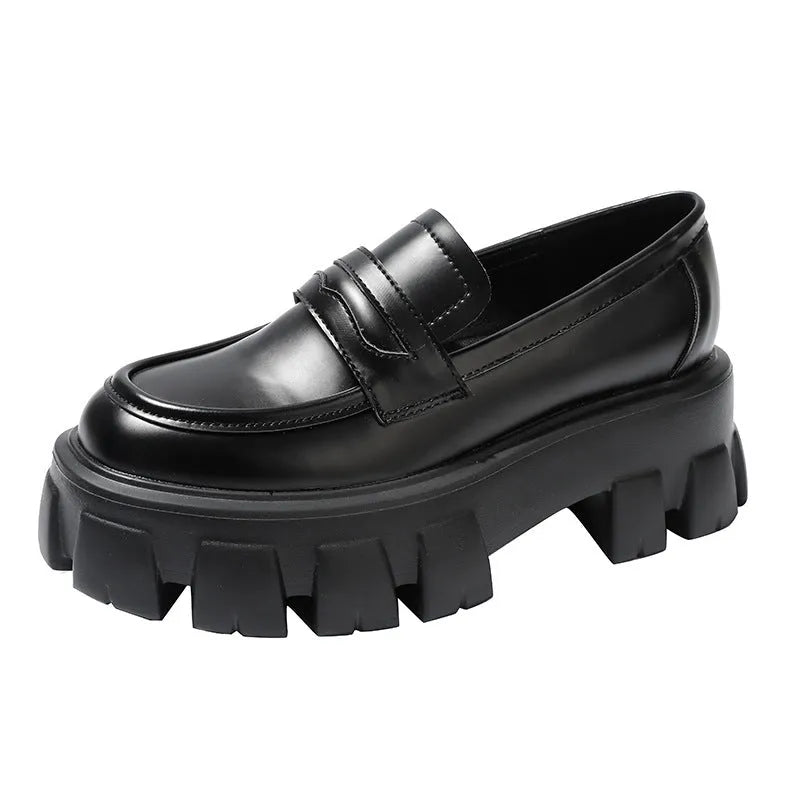 Women's wide fit patent leather loafers with a muffin heel and shallow opening on a rubber sole.