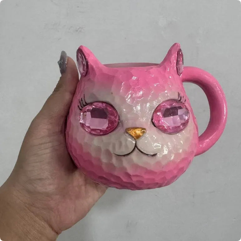 Colourful resin Crystal Earth Cat Cup craft decorative gift on a table.