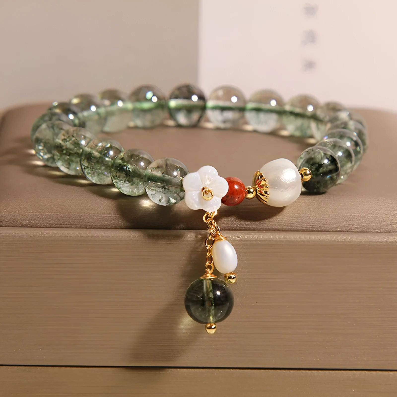 Green phantom quartz crystal bracelet with shell flower and Bells of Ireland design