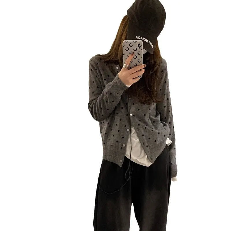 Gray women's loose-fit knitted cardigan with crocheted flower details on the front.