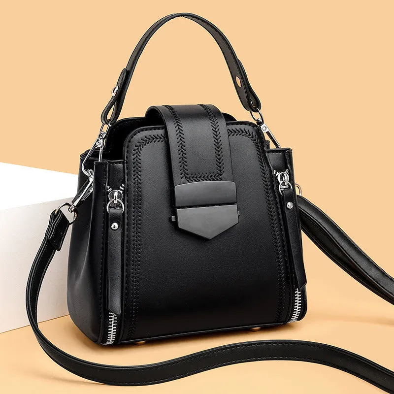 Small square vertical handbag in soft textured PU leather with sewing thread detail.