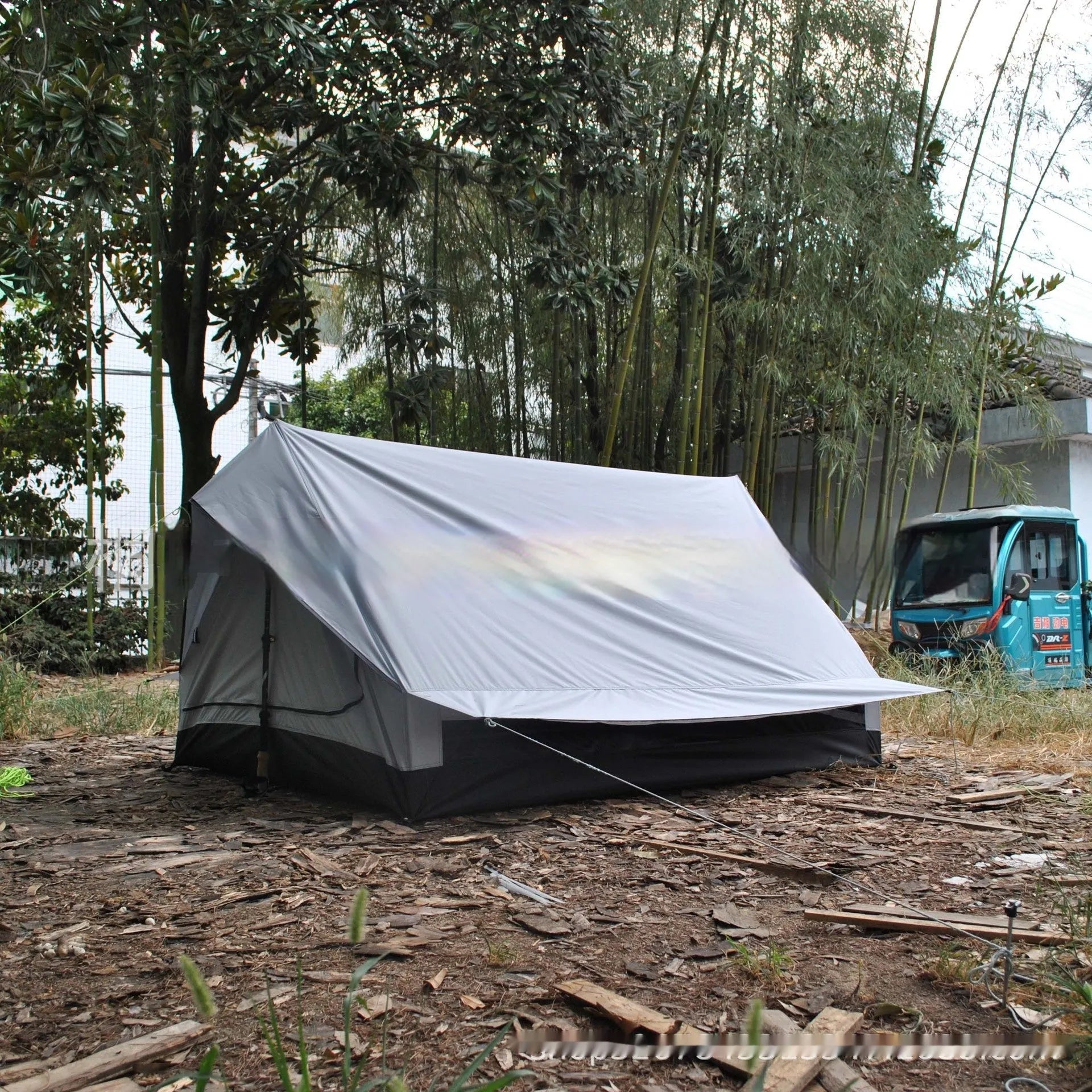 Brown A-line hiking tent erected with hiking poles showing spacious interior for 2-3 people
