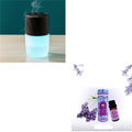 Mini portable jellyfish-shaped ultrasonic humidifier in black, with USB cable and essential oil bottle on a desktop