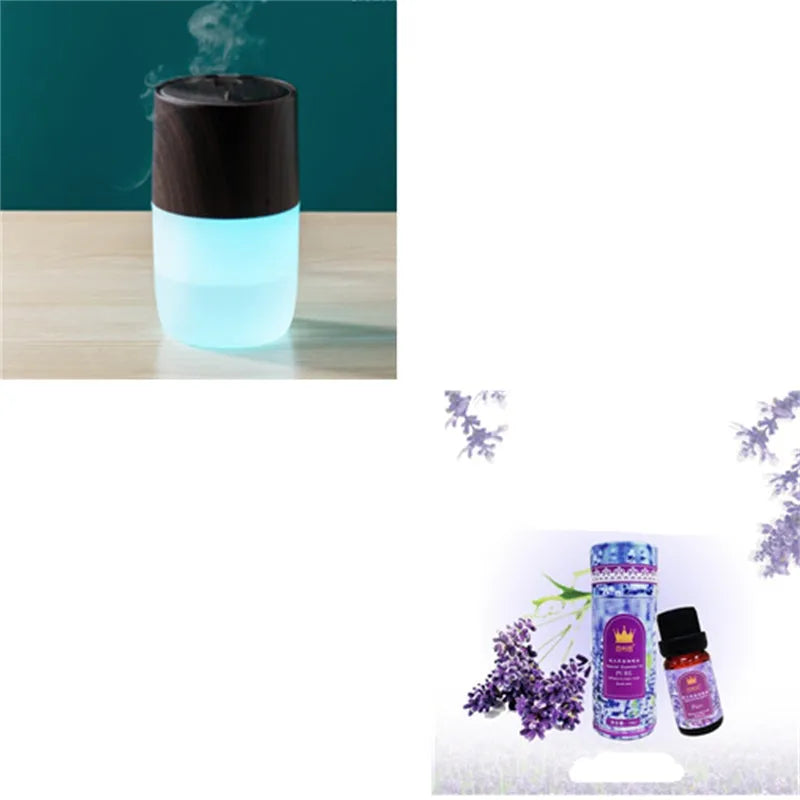 Mini portable jellyfish-shaped ultrasonic humidifier in black, with USB cable and essential oil bottle on a desktop
