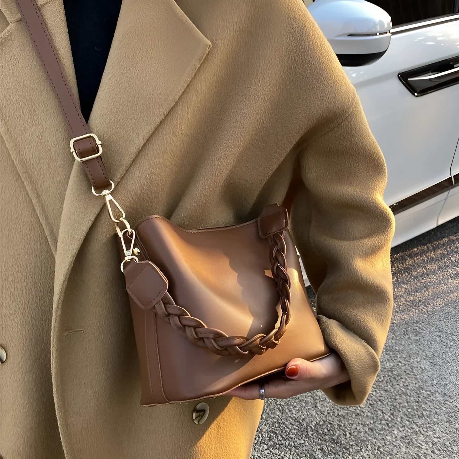 Khaki PU leather bucket bag with woven texture and a crossbody strap.