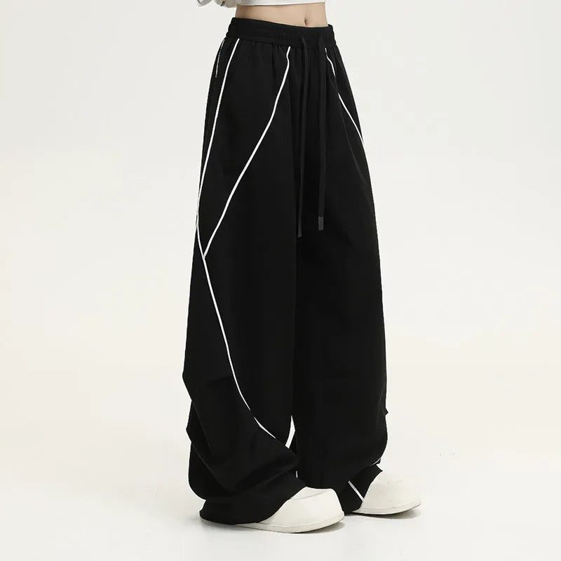 Black pleated wide-leg hip hop trousers with stripe pattern showing loose fit design