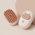 White pet steam brush with silicone teeth and water tank for cat and dog grooming