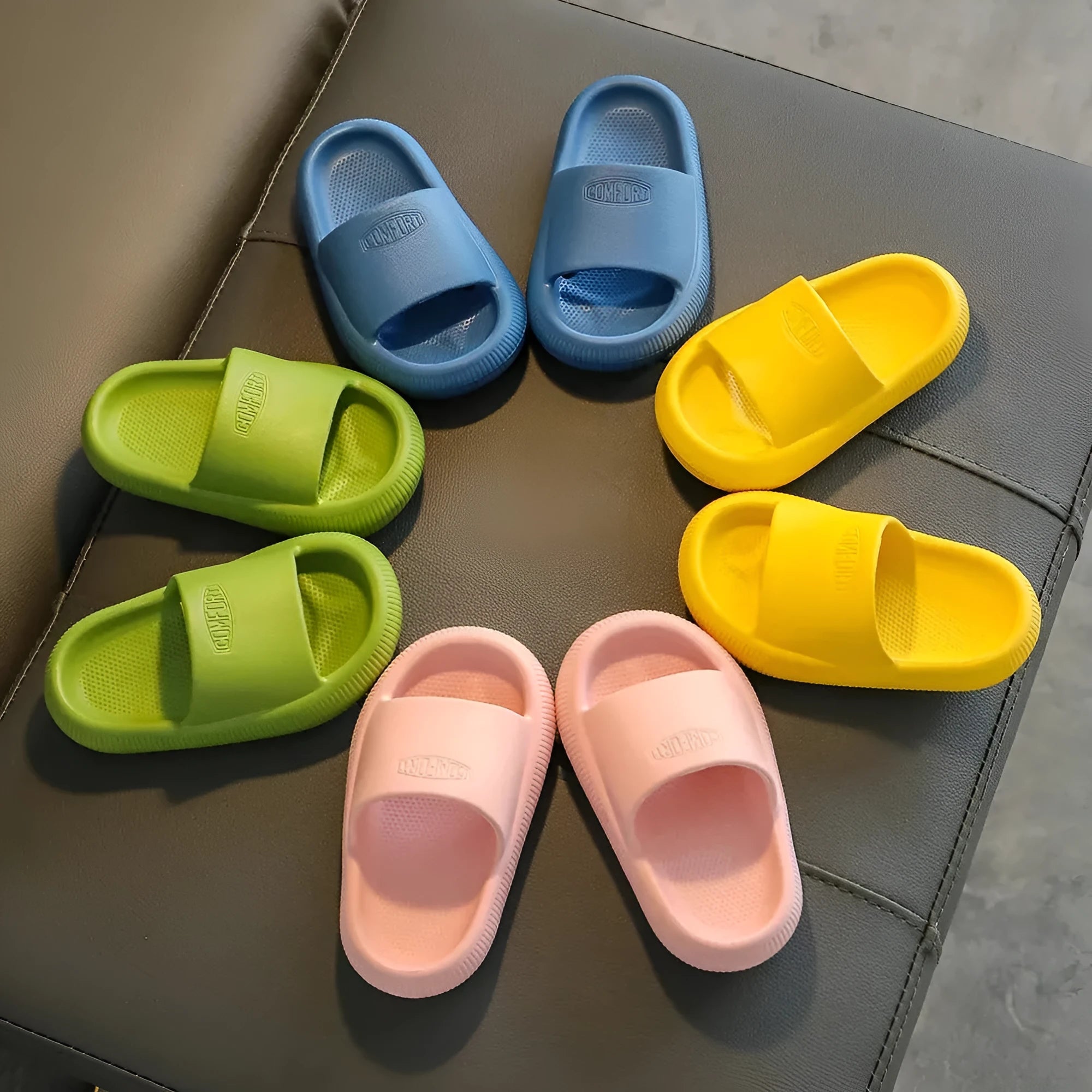 Children's mixed colour EVA slippers with a non-slip sole, shown in blue, green, orange, pink, and yellow.