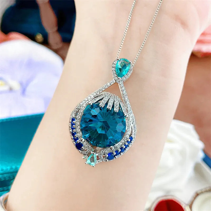 Blue crystal pendant necklace with geometric shape on water wave chain