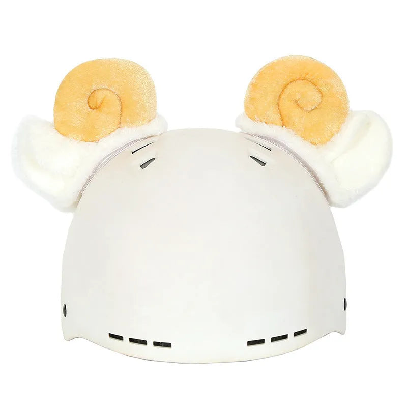 Soft plush cartoon helmet decoration sitting on top of a black ski boot.