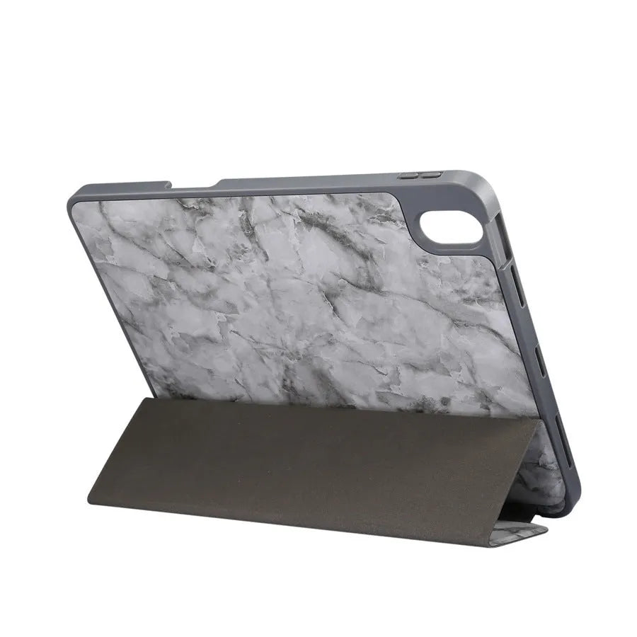 Dark grey marbling pattern iPad case folded in a stand position, showing the Apple Pencil slot.