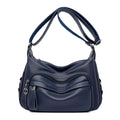 Large blue PU crossbody shoulder bag with multiple internal compartments and luggage-style design
