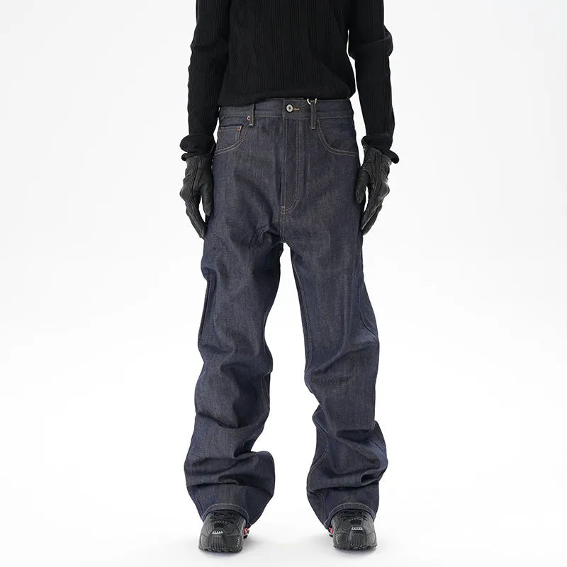 Man wearing dark blue loose straight-leg casual jeans.