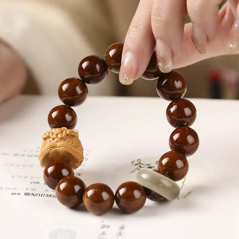 Hand-woven 13mm round bead bracelet in ivory nut lion style with single circle design