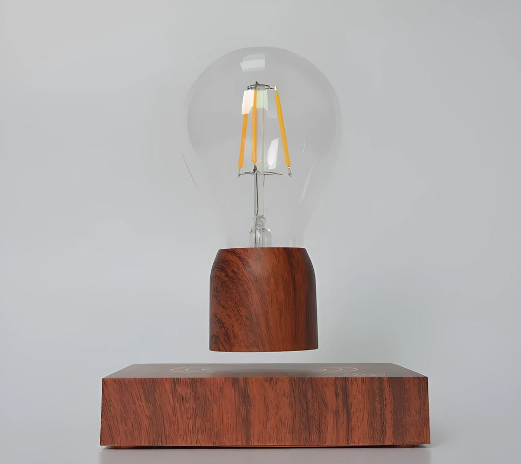 Magnetic levitation light bulb floating above wood-effect base with international plug adapters