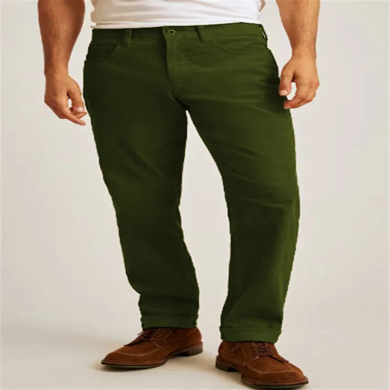 A pair of loose straight-leg corduroy trousers in an army green colour, laid flat.