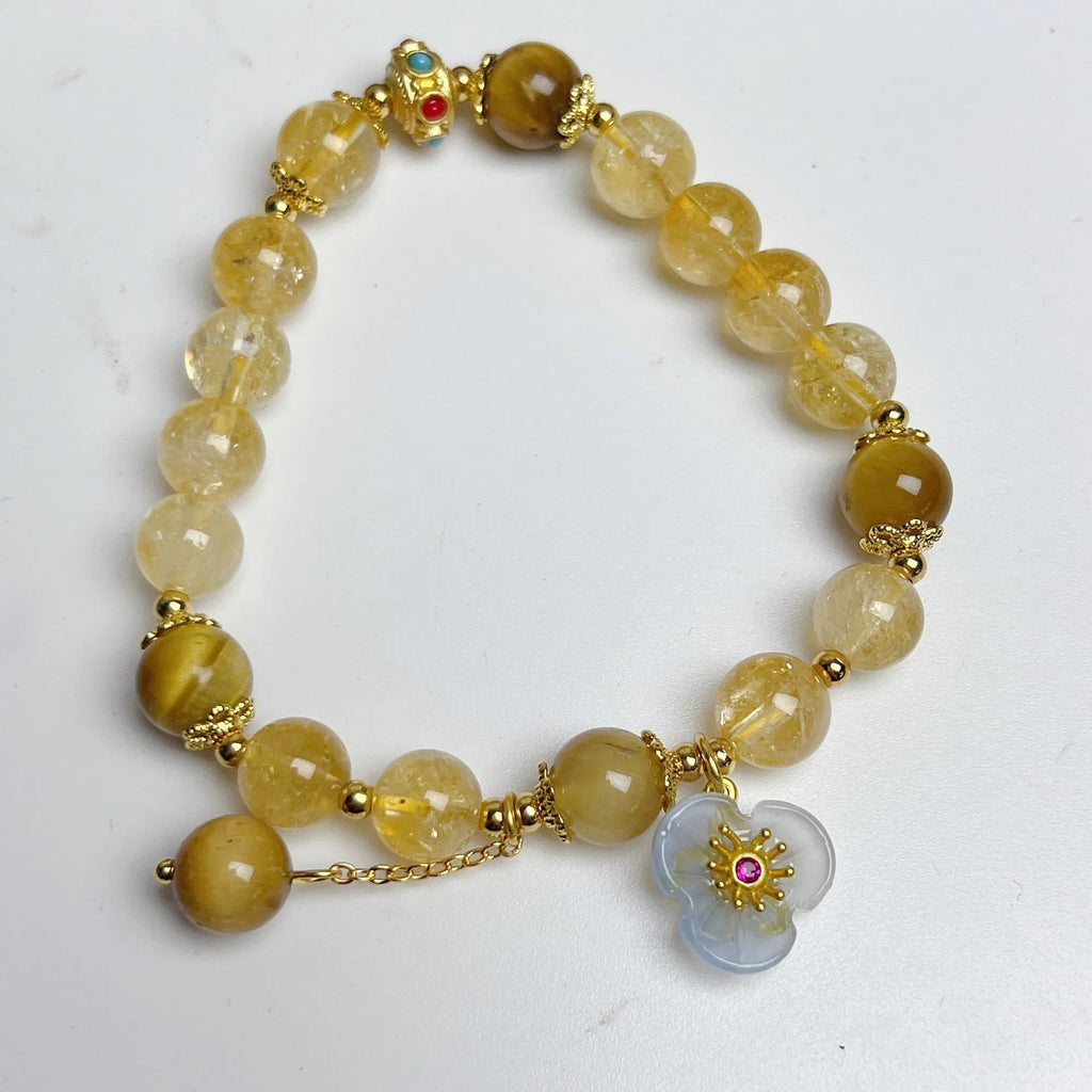 Golden yellow citrine crystal bracelet with flower and tassel detail for women.
