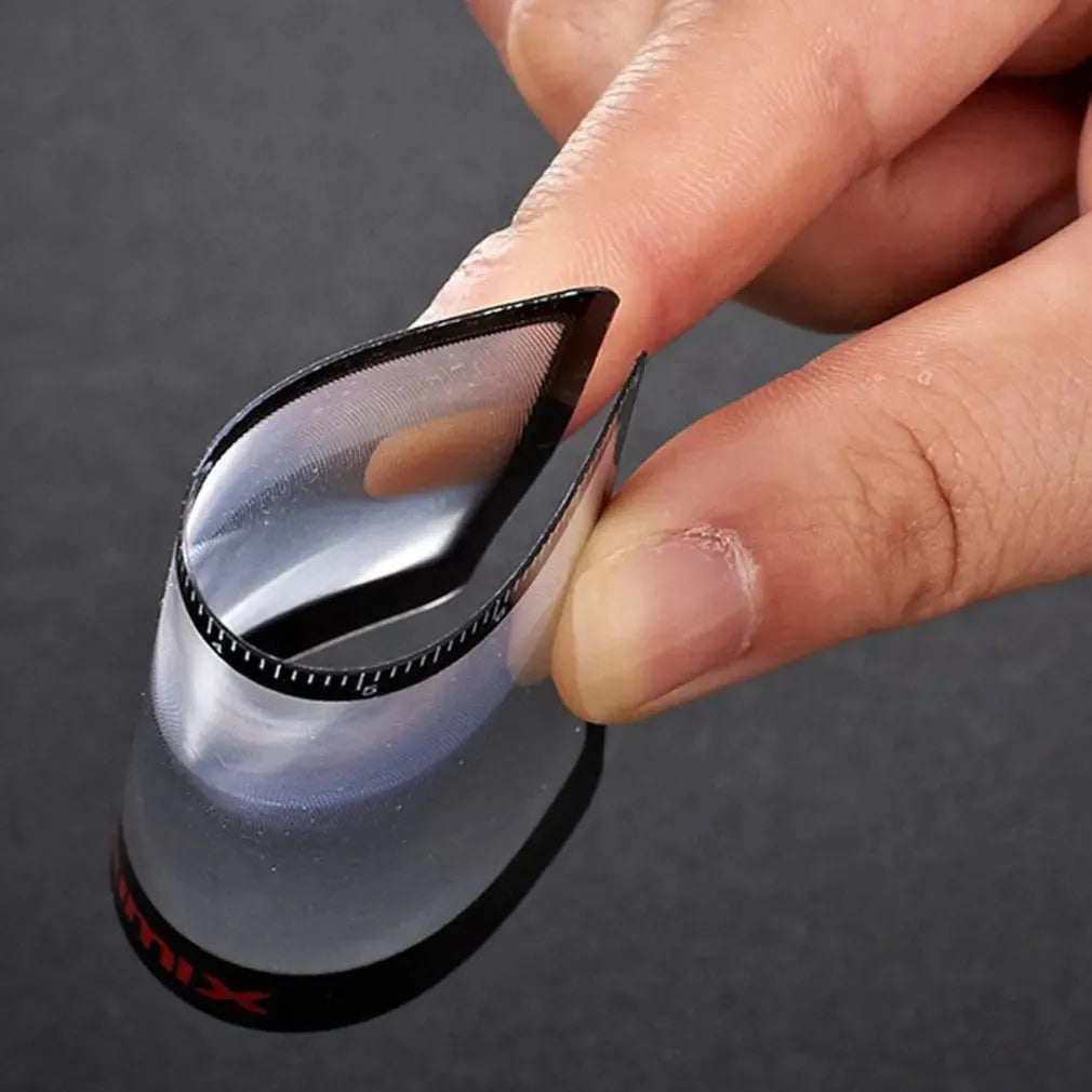 A thin, credit-card sized black plastic magnifier with a Fresnel lens, shown next to a bank card for scale.