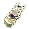 Unisex geometric bracelet with rough natural crystals and gold winding metal on a wrist.