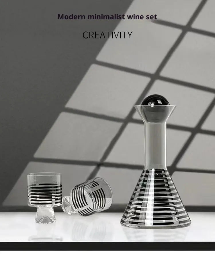Modern black striped glass cold water bottle 1000ml with two cups on a light surface