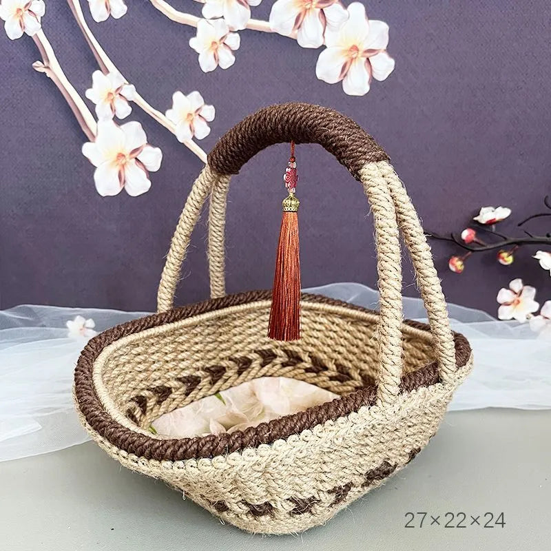 Hand-woven straw basket with hemp rope binding in coffee brown colour, 19cm long by 12cm wide.