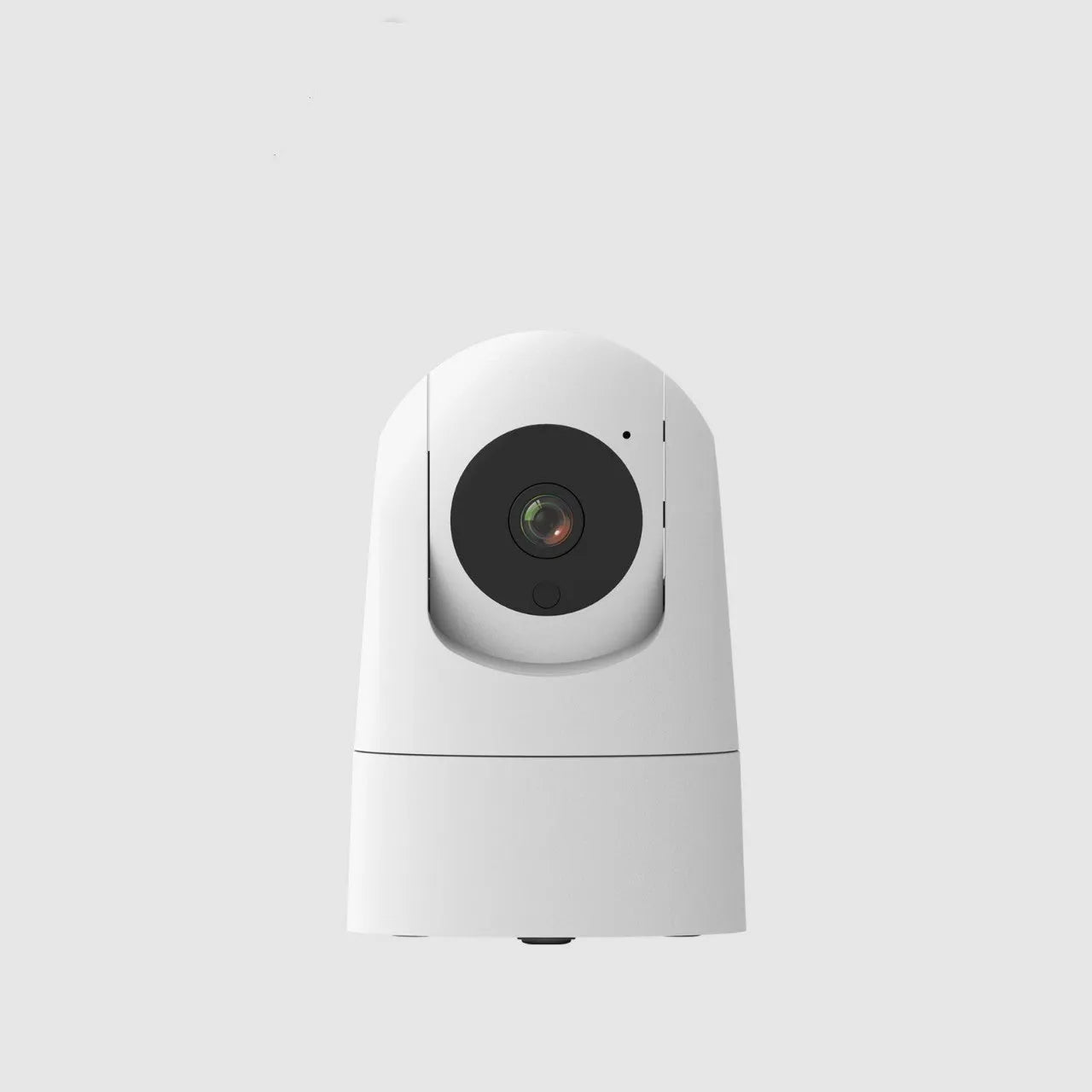 White indoor security camera with adjustable lens on a desk next to its power adapter.
