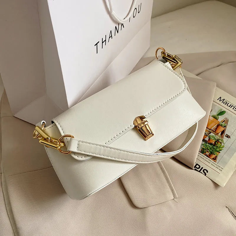 Brown French style casual underarm bag with a single shoulder chain, showing sandwich pocket and sewing thread detail.