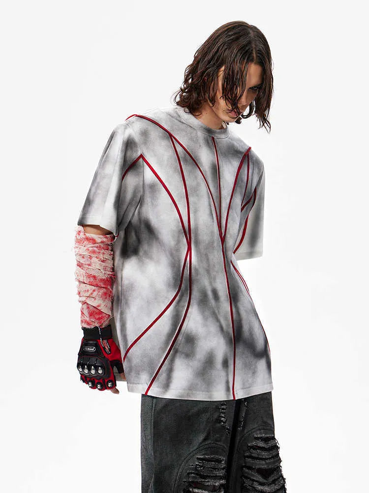 Padded shoulder short sleeve T-shirt with three-dimensional line patchwork detail on a round neck.