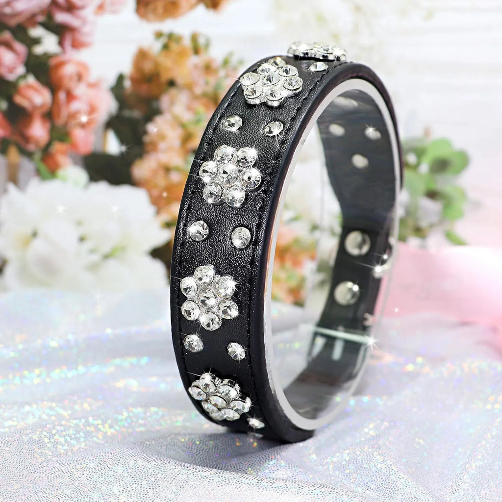 Decorative black dog collar with rhinestone flower pattern and studs on soft PU leather.