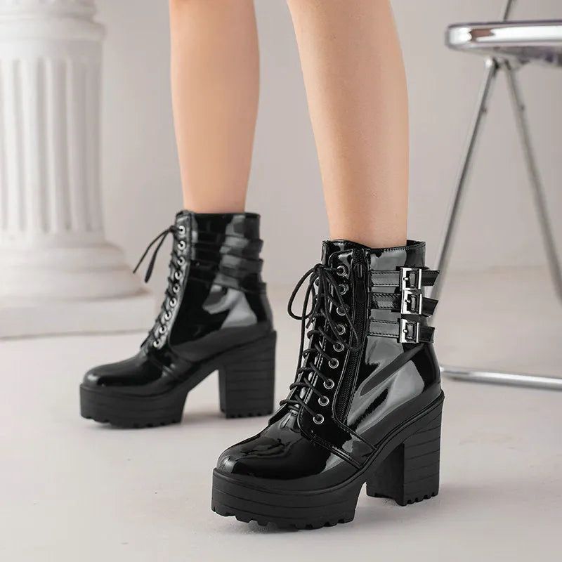 Women's black chunky heel ankle boots with lace-up front and round toe.