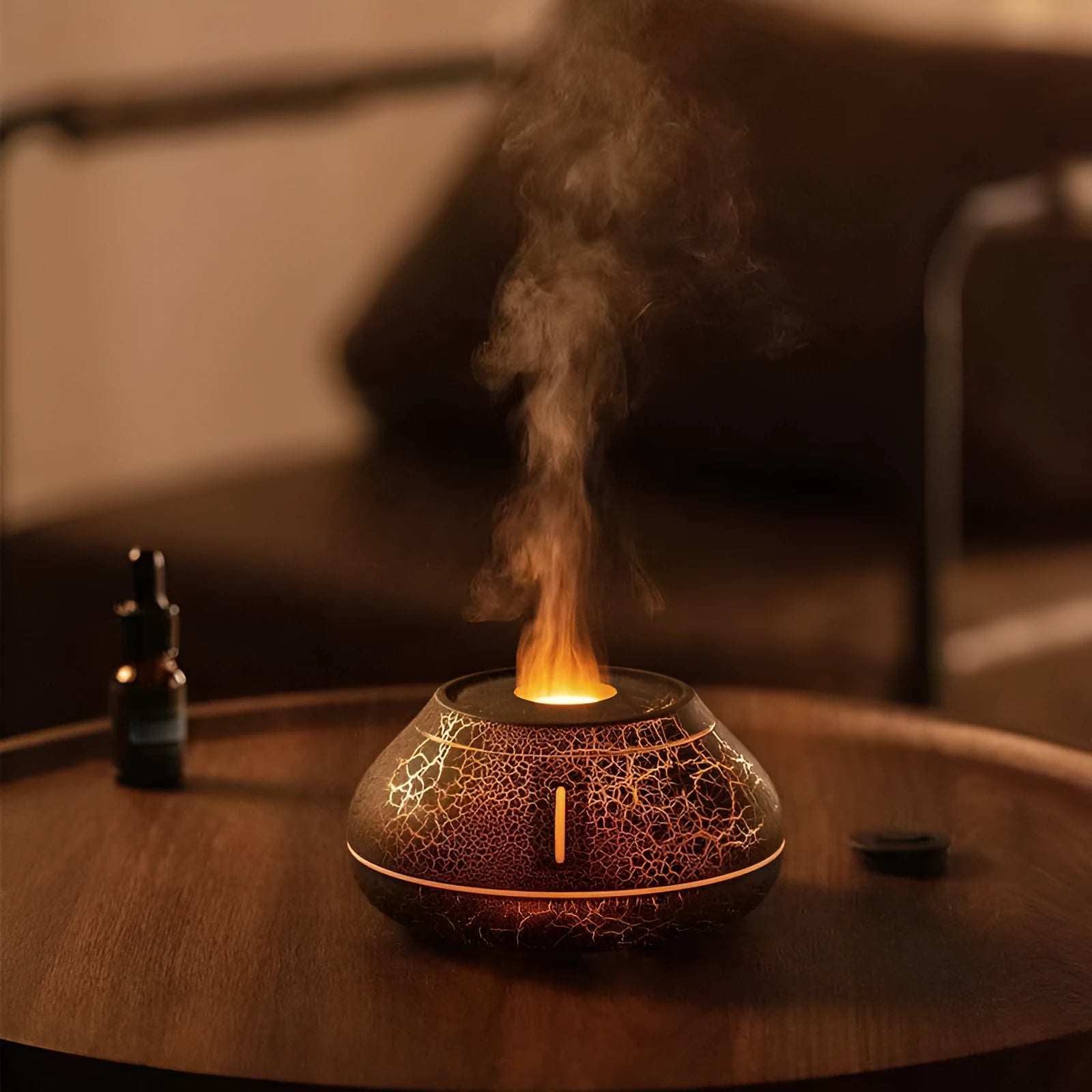 Round white flame effect aroma diffuser humidifier with colourful LED lighting on wooden desk